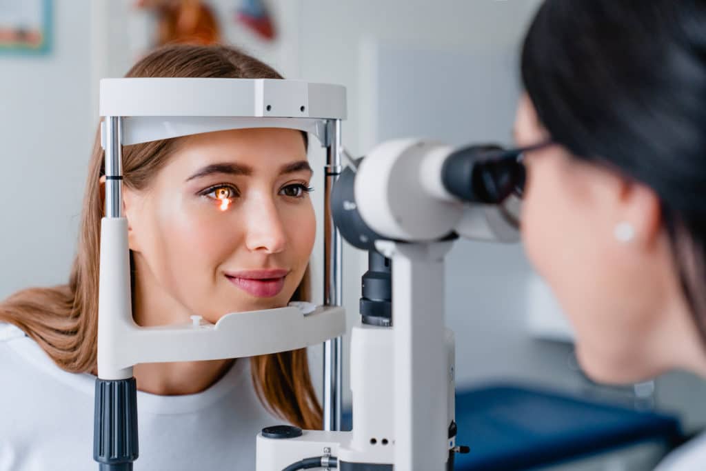 woman's eyes examined female doctor photophobia